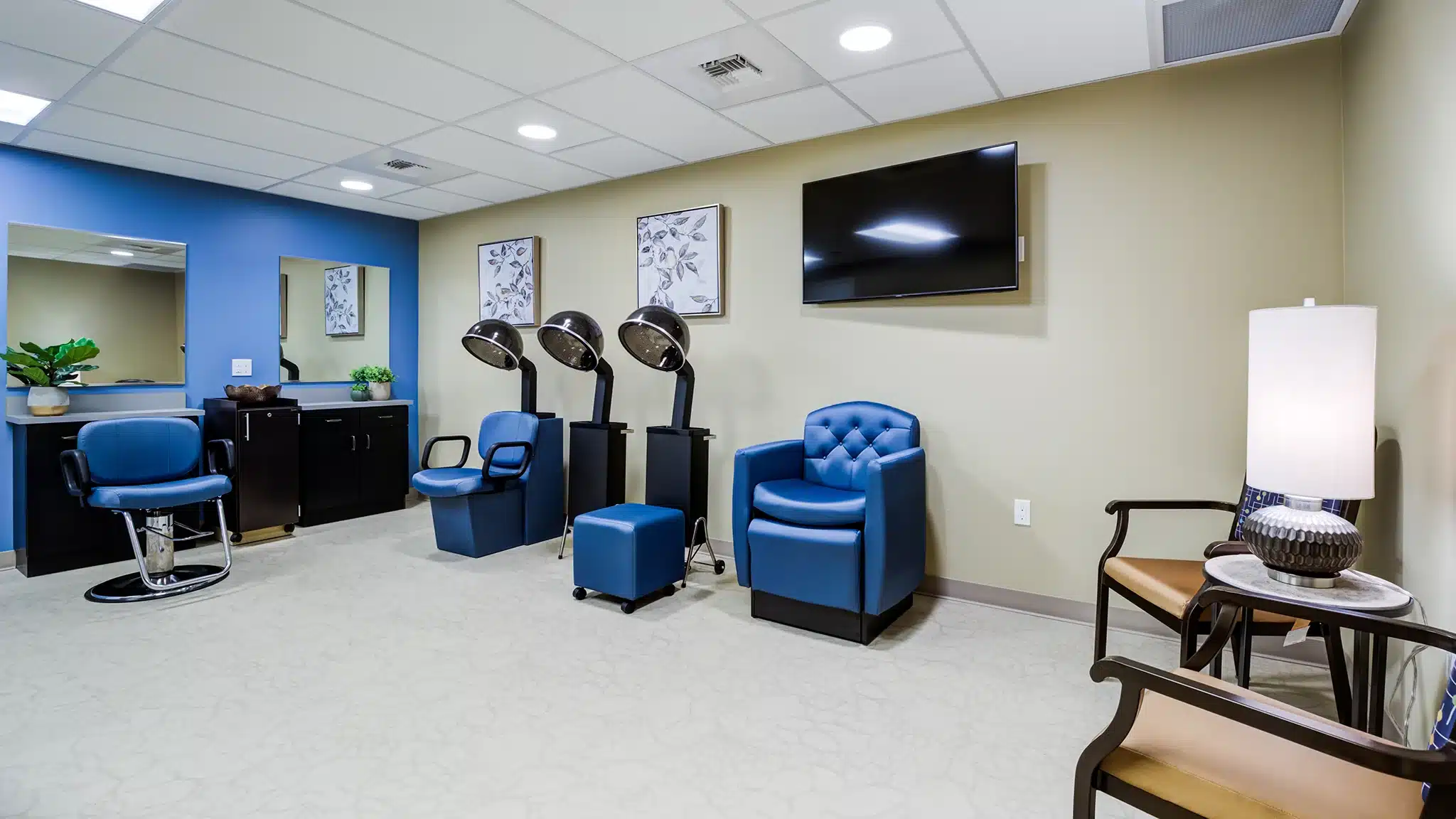 Comfortable Spa area with armchairs and television in a senior living community.