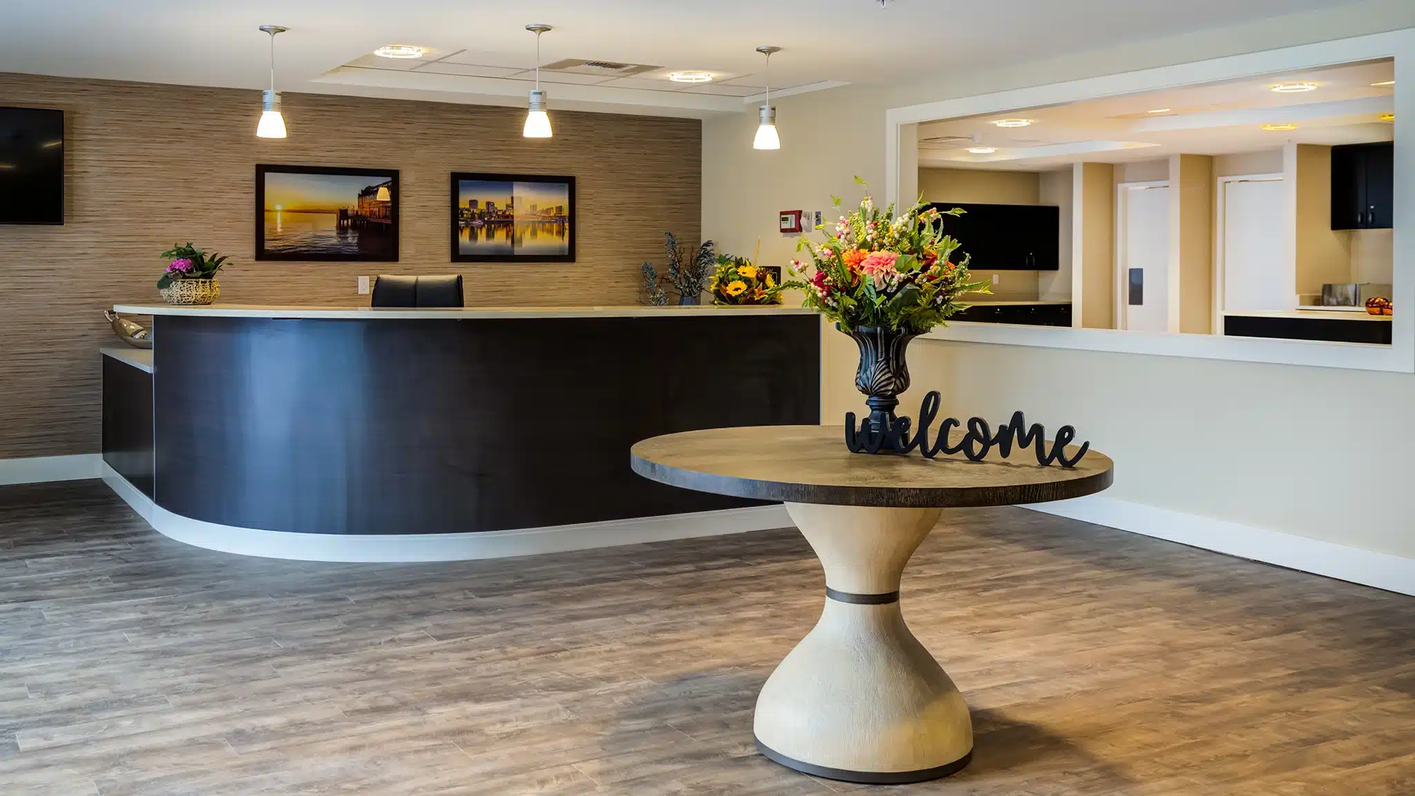 Reception and welcome area with front desk in a senior living community.