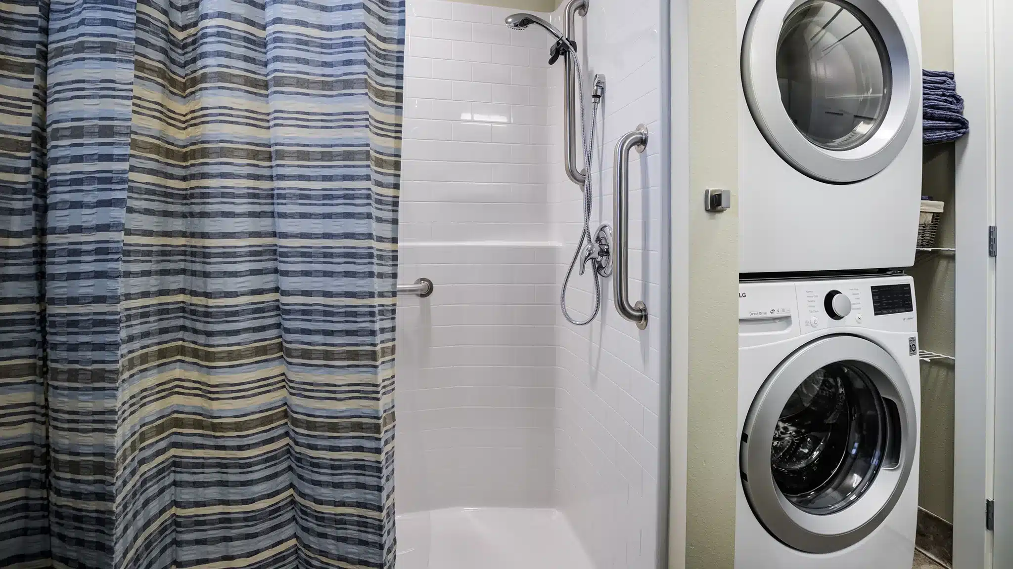 Stacked washer and dryer located in a senior living apartment.