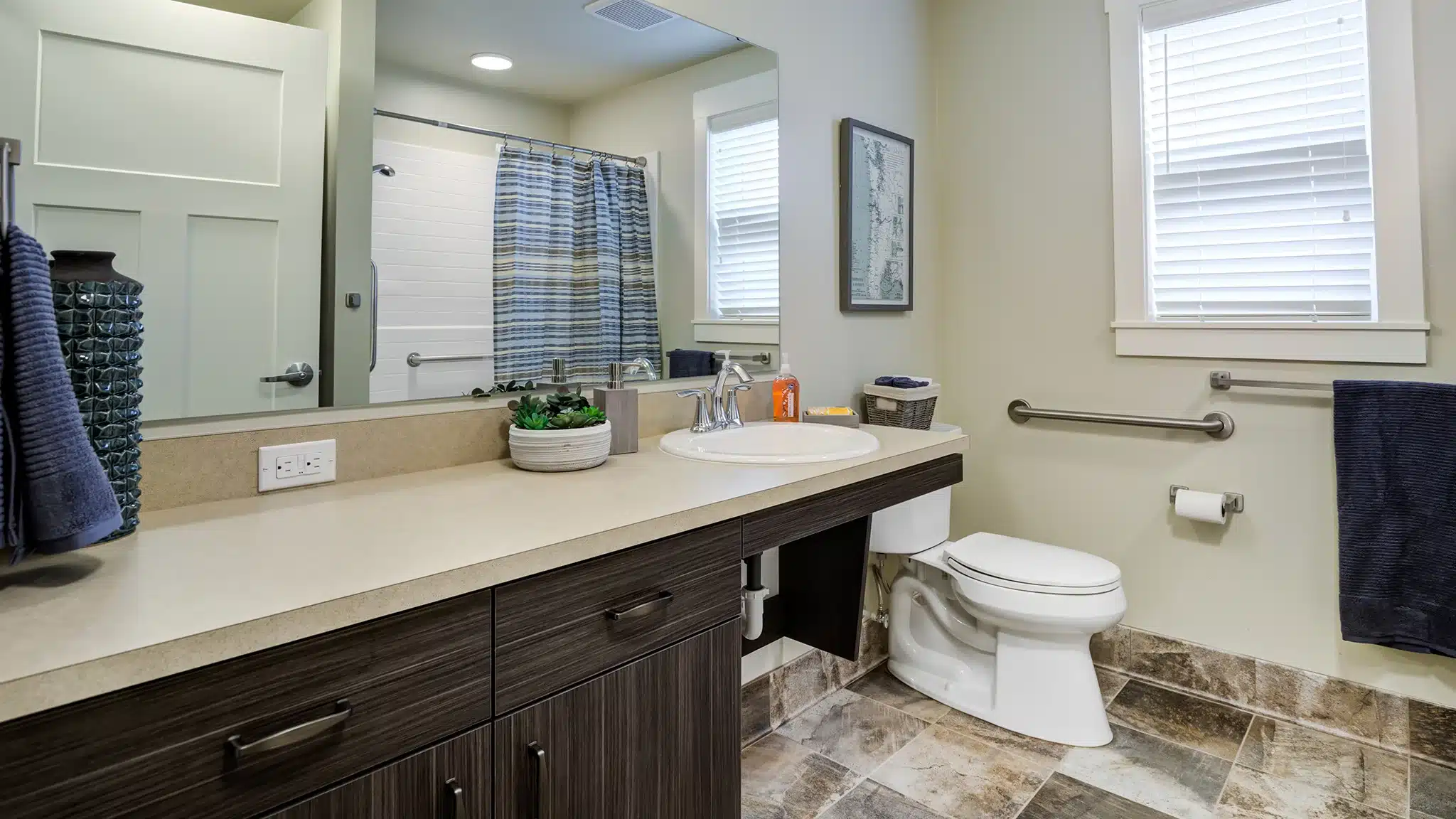 Bathroom with walk-in shower and vanity designed for senior living.