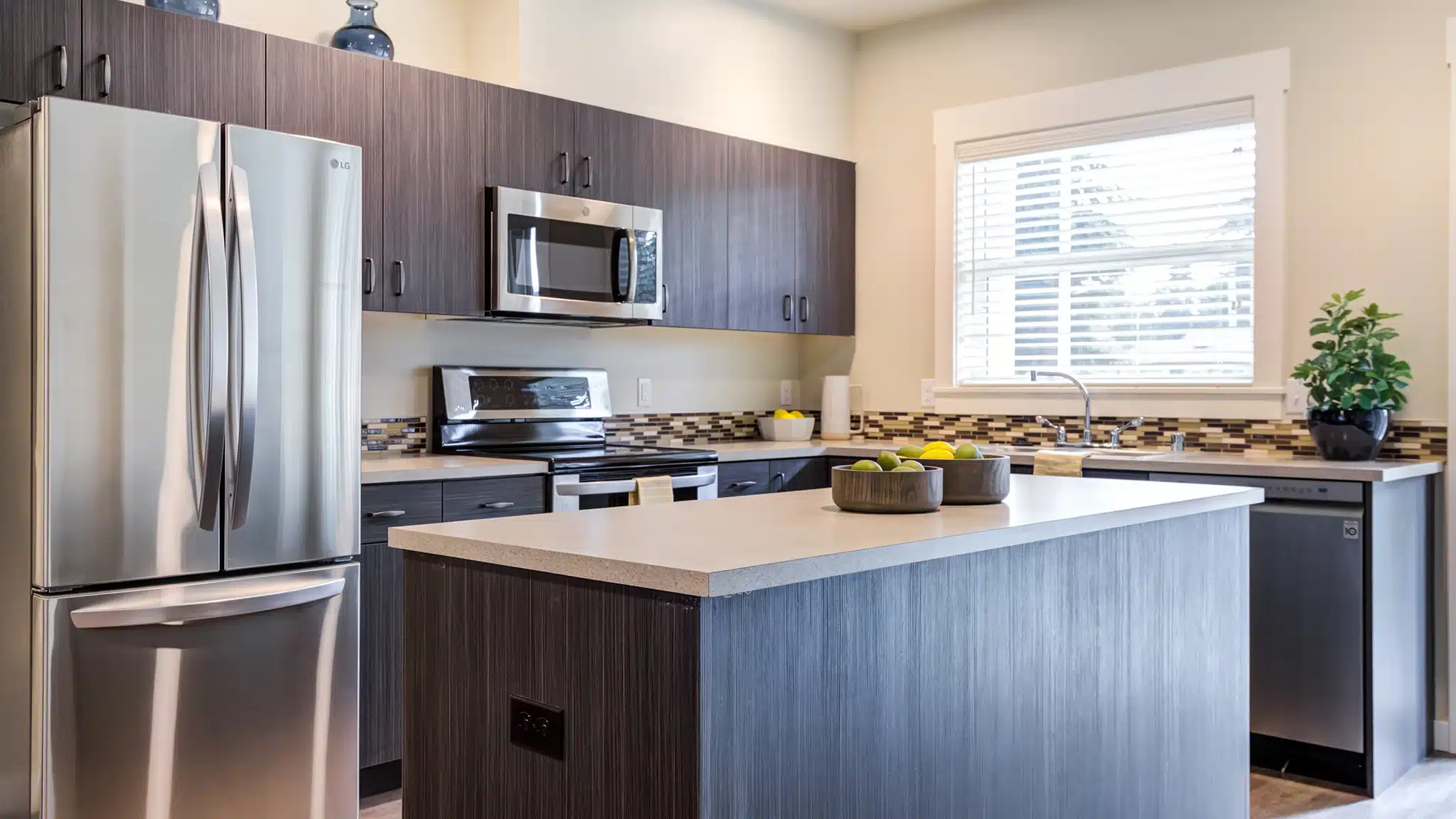 Modern kitchen with appliances and island in a senior living apartment
